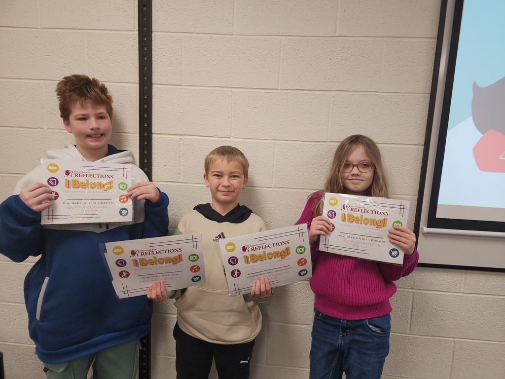 Reflections winners standing with their certificates with the theme I Belong!