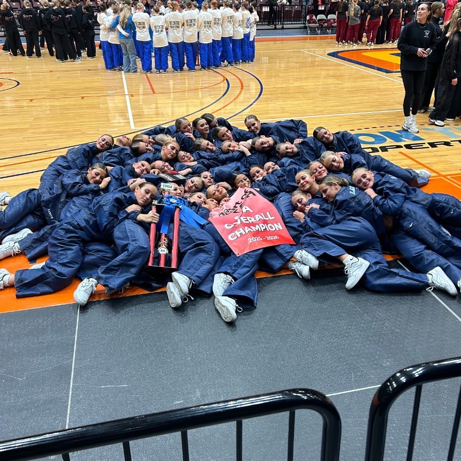 lancelles posing with their 1st place trophy and banner