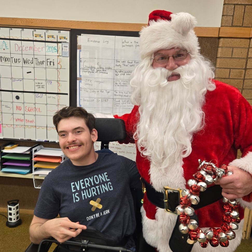 Santa and a student posing for a picture