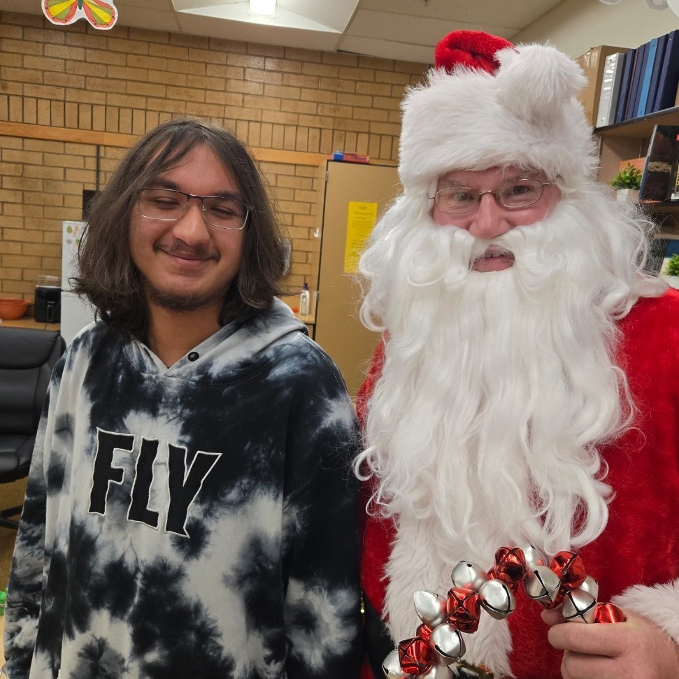 Santa and a student posing for a picture