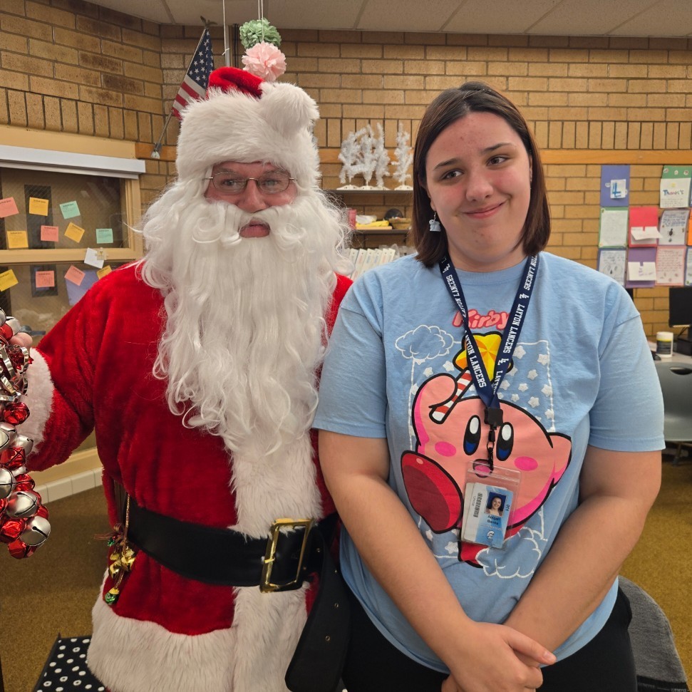 Santa and a student posing for a picture