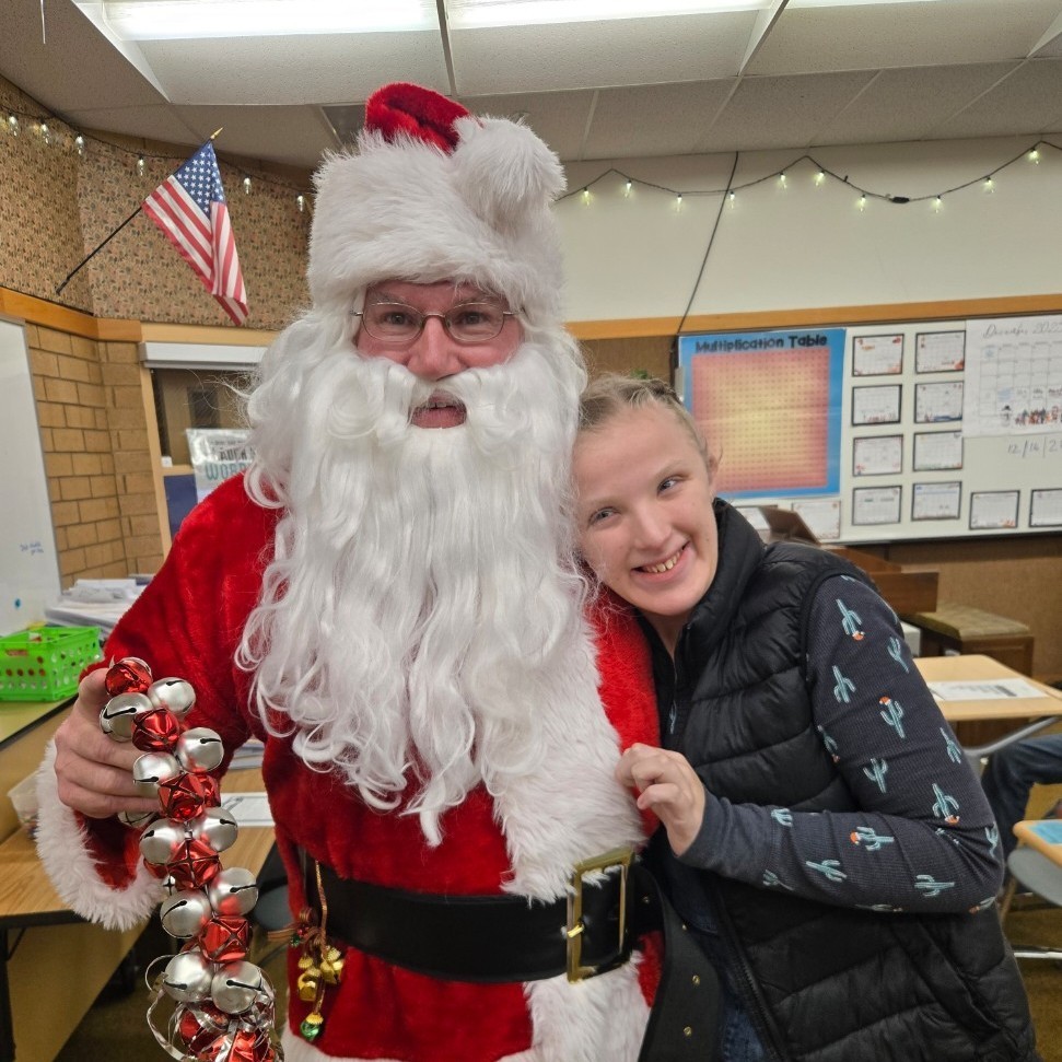 Santa and a student posing for a picture