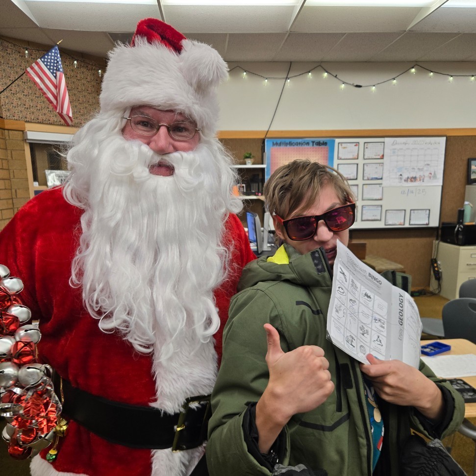 Santa and a student posing for a picture