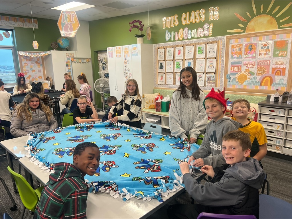 students with a super mario blanket in front of them