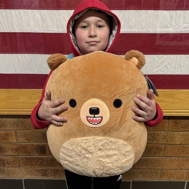 Student attendance winner with plush toy. 