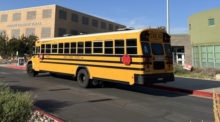 School bus in front of school.