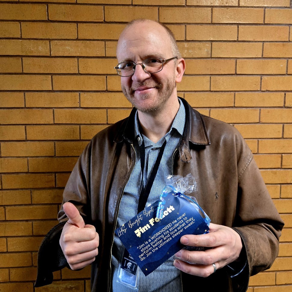 Mr. Follett holdiAward. teacher Bright Spot award.