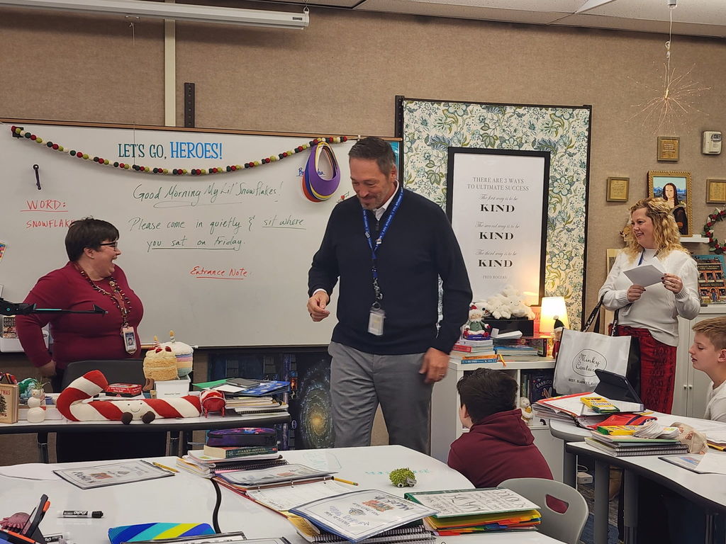 Mr. Nash in Ms. Lloyd's classroom giving her an award.