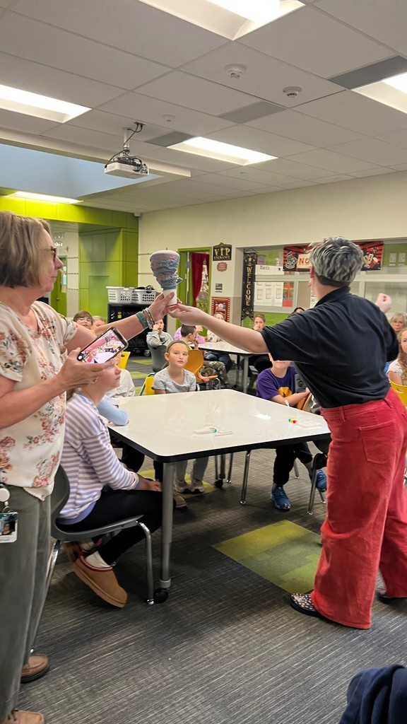 students watching a guest presenter demonstrating chemical reactions.