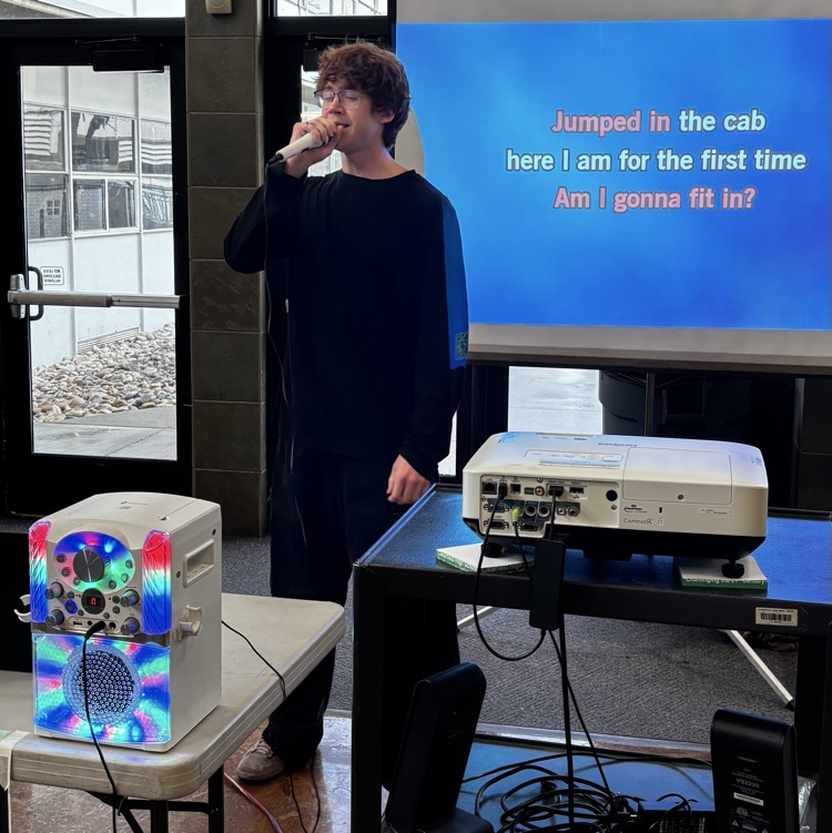 Student singing during a Karaoke party in the commons at lunch