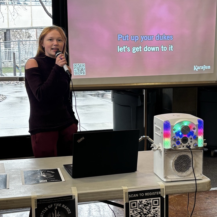 Student singing during a Karaoke party in the commons at lunch