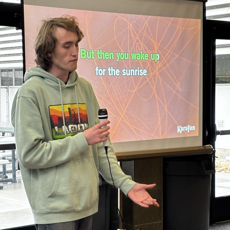 Student singing during a Karaoke party in the commons at lunch today