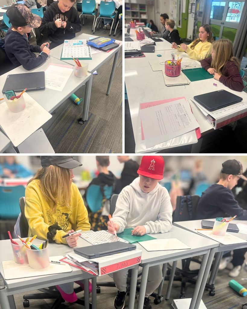 Students sit at tables in a classroom working on math activities. They are using worksheets, dry-erase boards, markers, and laptops while collaborating and focusing on their work during class time.