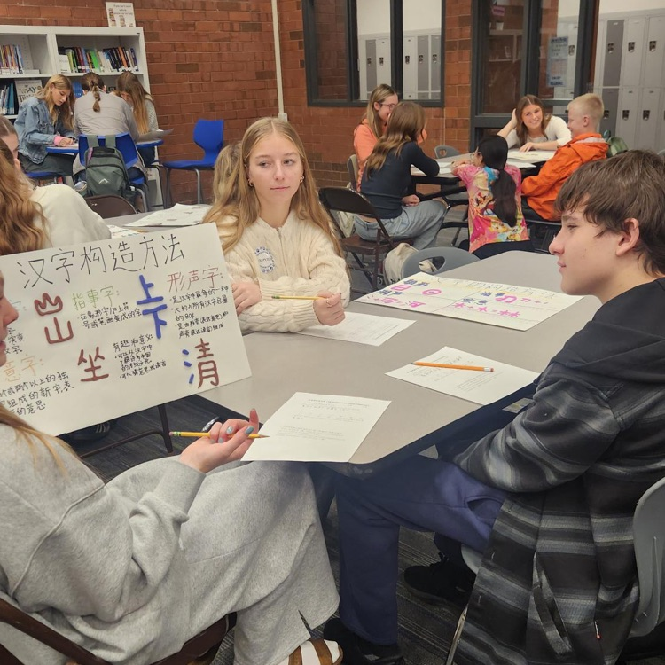high school students showing jr high students a chinese project