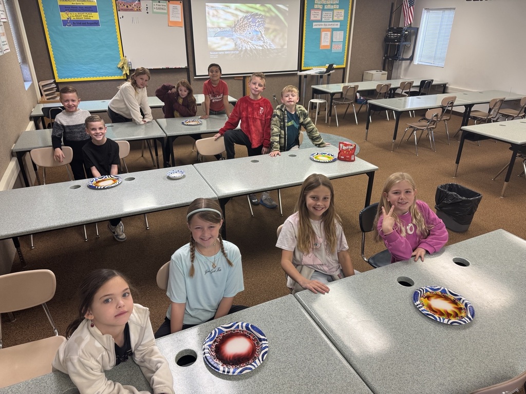 a group of students smiling with a skittles experiment