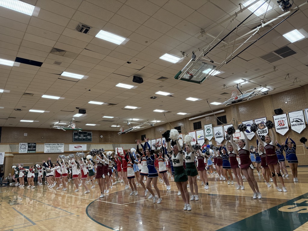 All cheerleaders performing a dance. 