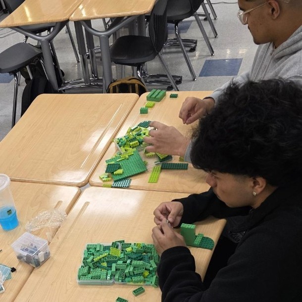 two students sorting legos