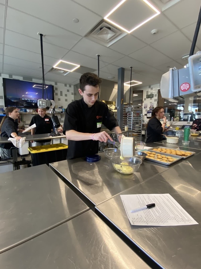 culinary student pouring cookie batter