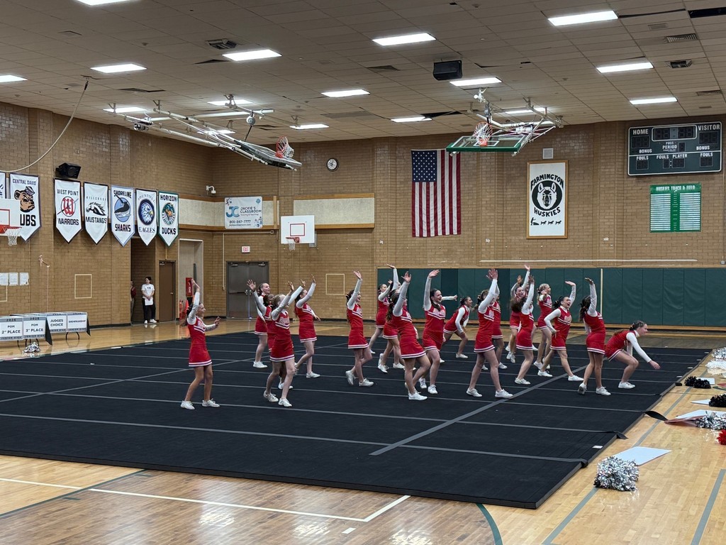 image of cheerleaders stunting on mats