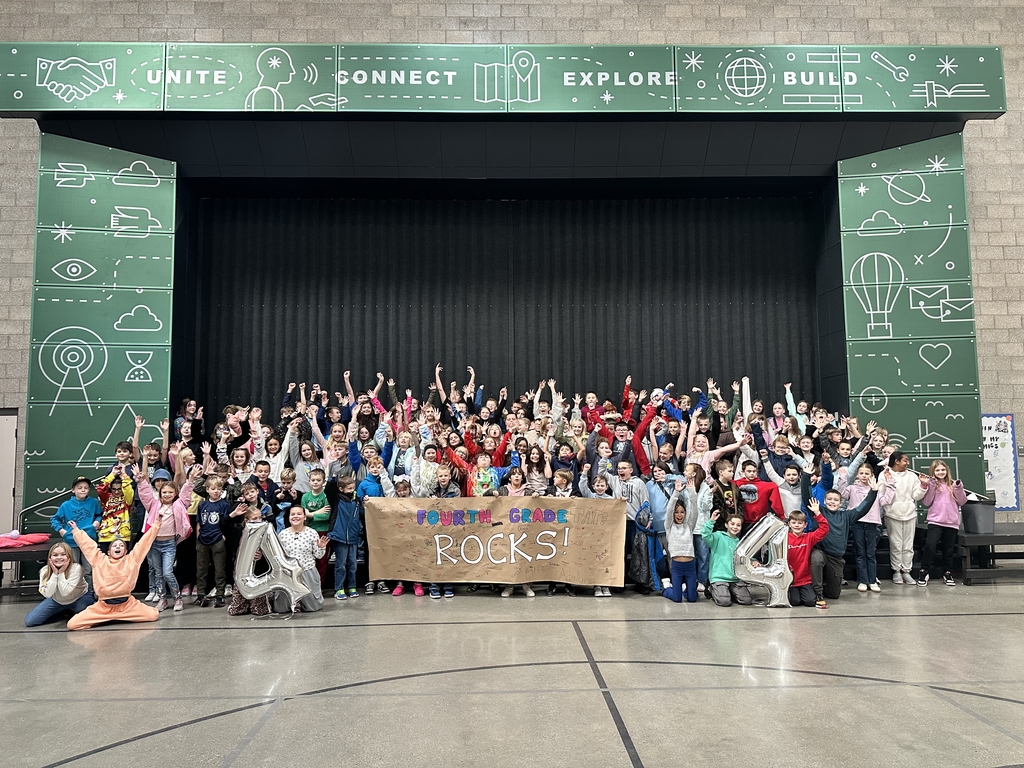 group of students holding fourth grade rocks banner