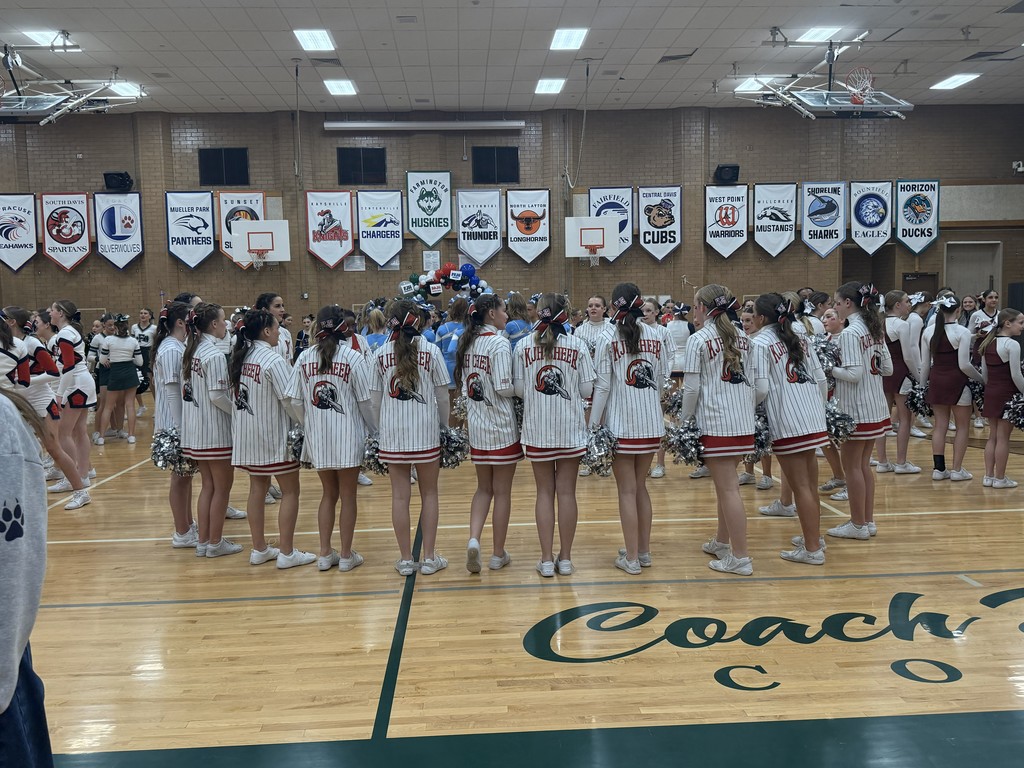 image of cheerleaders standing in a circle holding hands