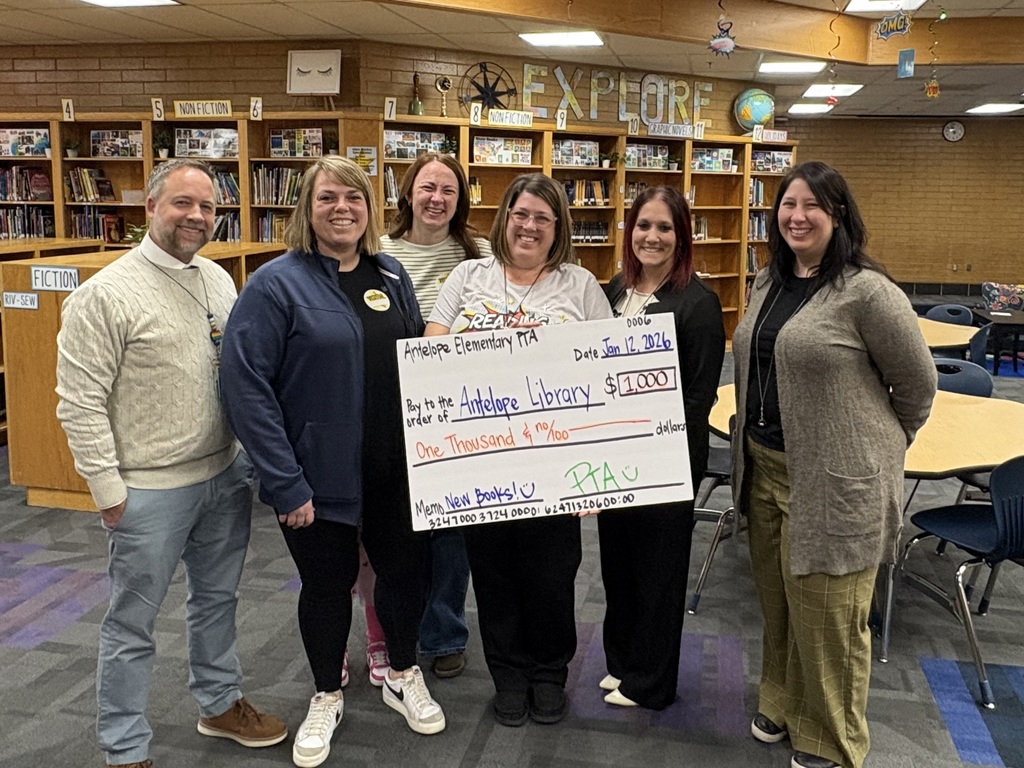 PTA presenting a one thousand dollar check to the library for new books