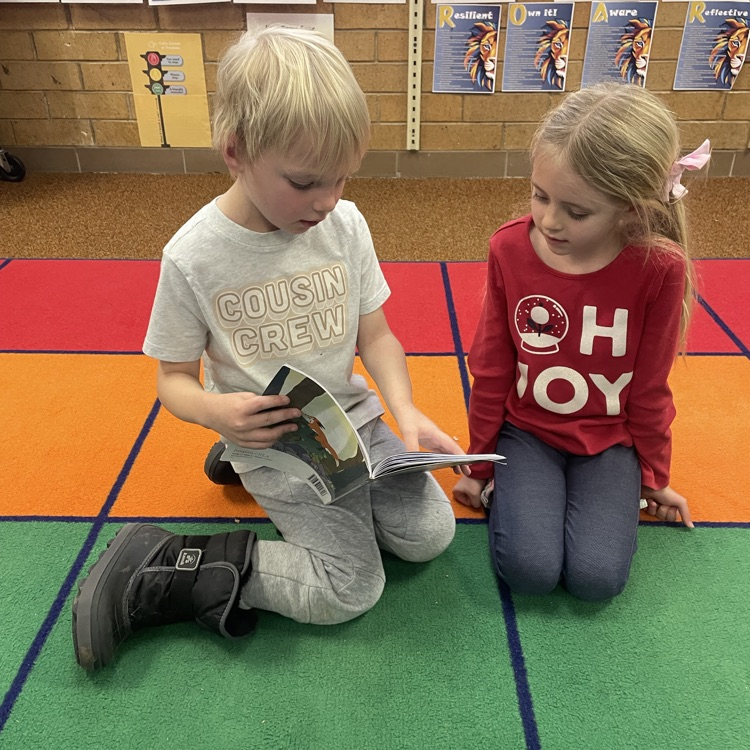 Students reading together - practicing skills they’ve been learning in class