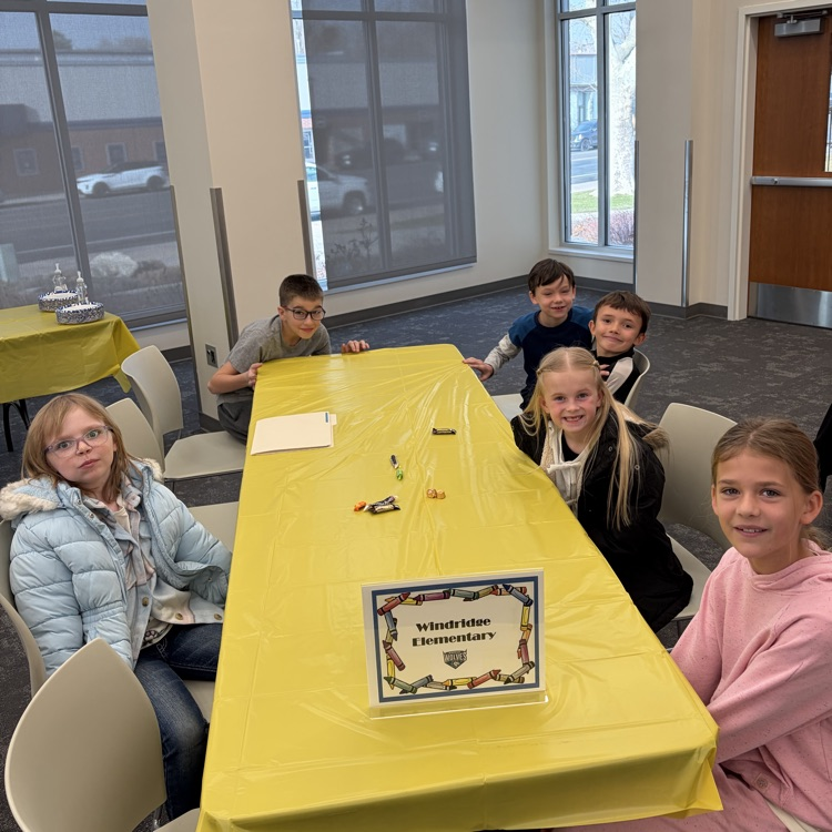 Our students are shown seated at their table just after arriving at The lunch with the Mayor activity.