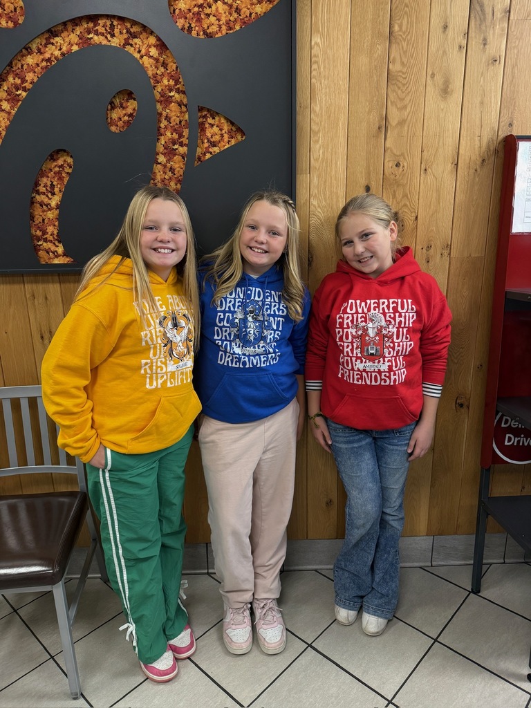 Three smiling students in colorful clothes