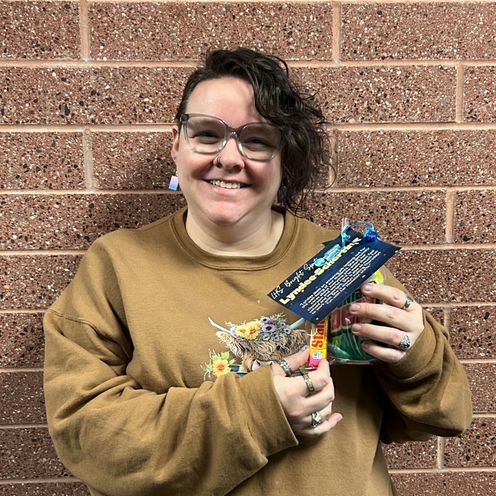 Mrs. Scherting holding her Bright Spot Award