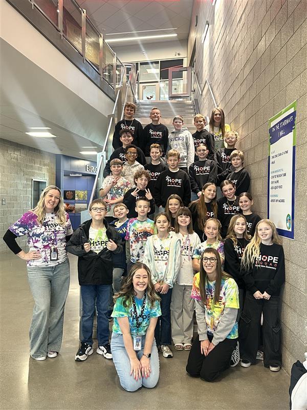 large group of students with Hope Squad shirts on and 4 women smiling at camera