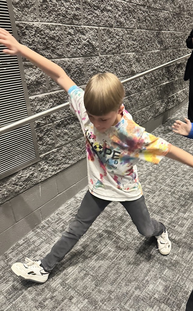 boy dancing with hope squad shirt on