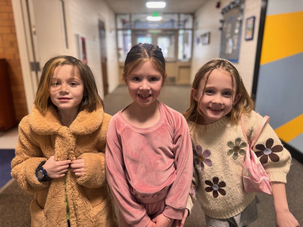 Three first grade girls in the school hallway