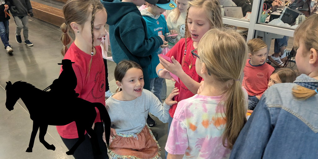 Students crouching and reading a card.