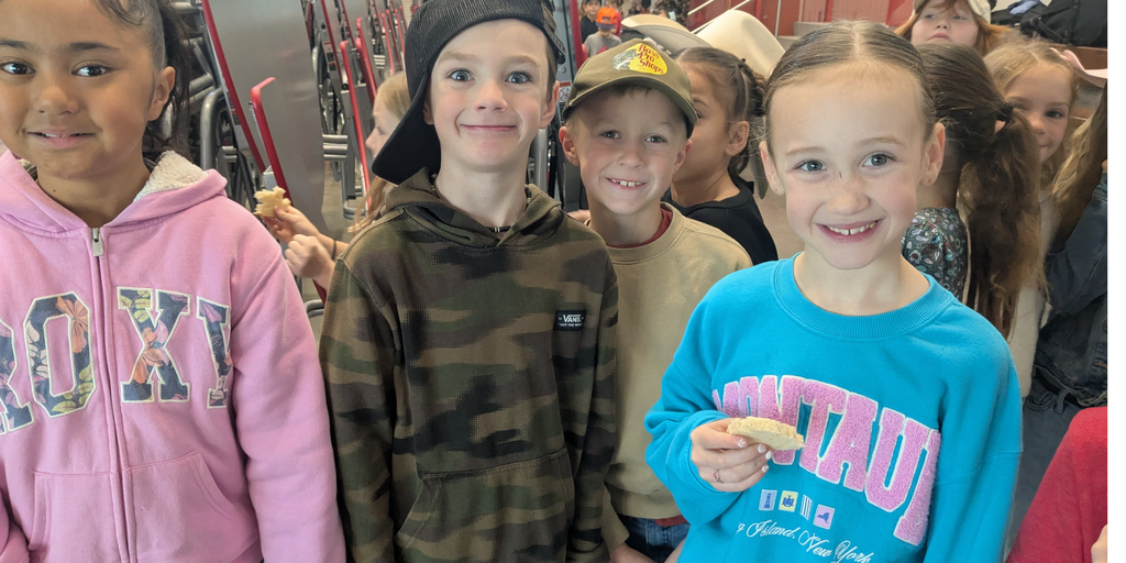 Students posing for a picture with bread. 