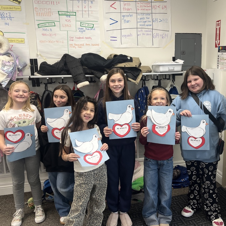 six girls holding a paper with a dove on it