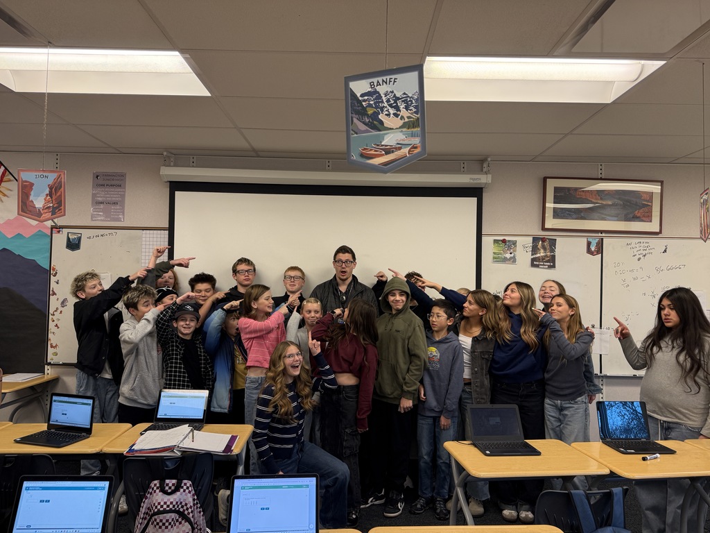 Mr. Lebaron and students pointing to him. 