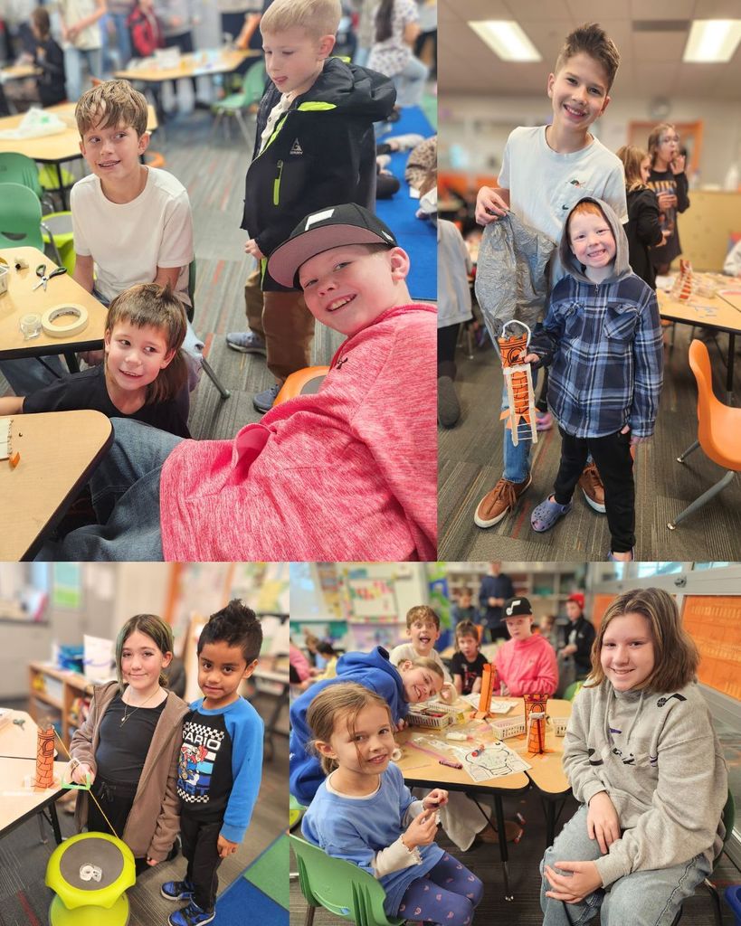 Pairs and small groups of 6th grade buddies posing with kindergarten students beside their paper tower projects during buddy time in the classroom.