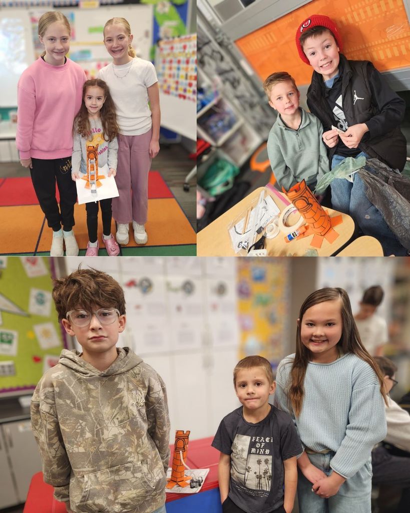 Pairs and small groups of 6th grade buddies posing with kindergarten students beside their paper tower projects during buddy time in the classroom.