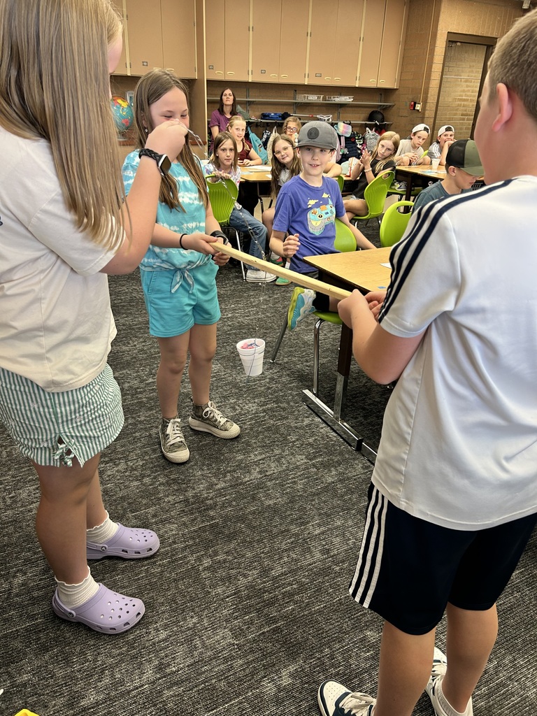STEM Club creating pulley's out of paper clips and cups.