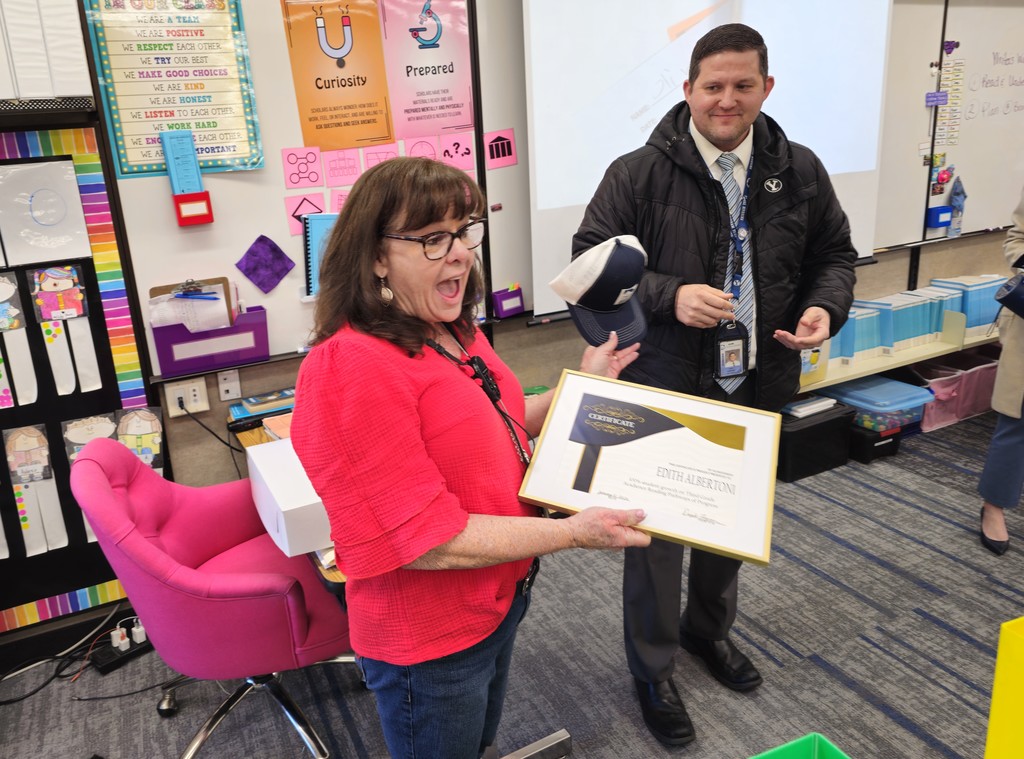Doug Forsgren presents an award to Mrs. Albertoni in her classroom.