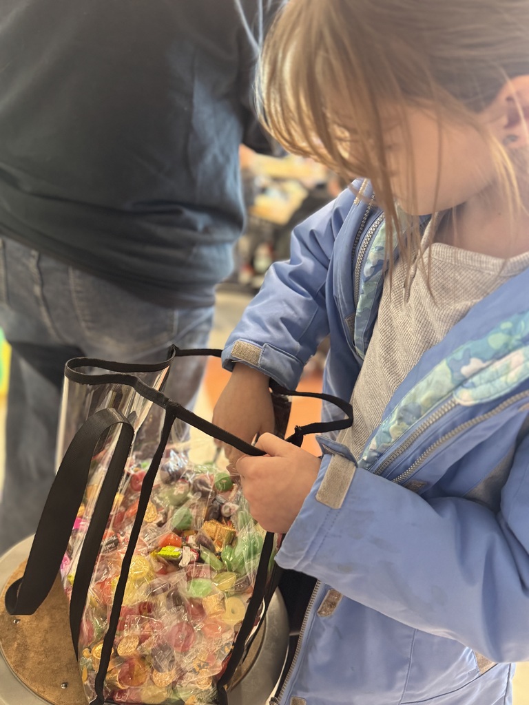 student pulling candy from a bag