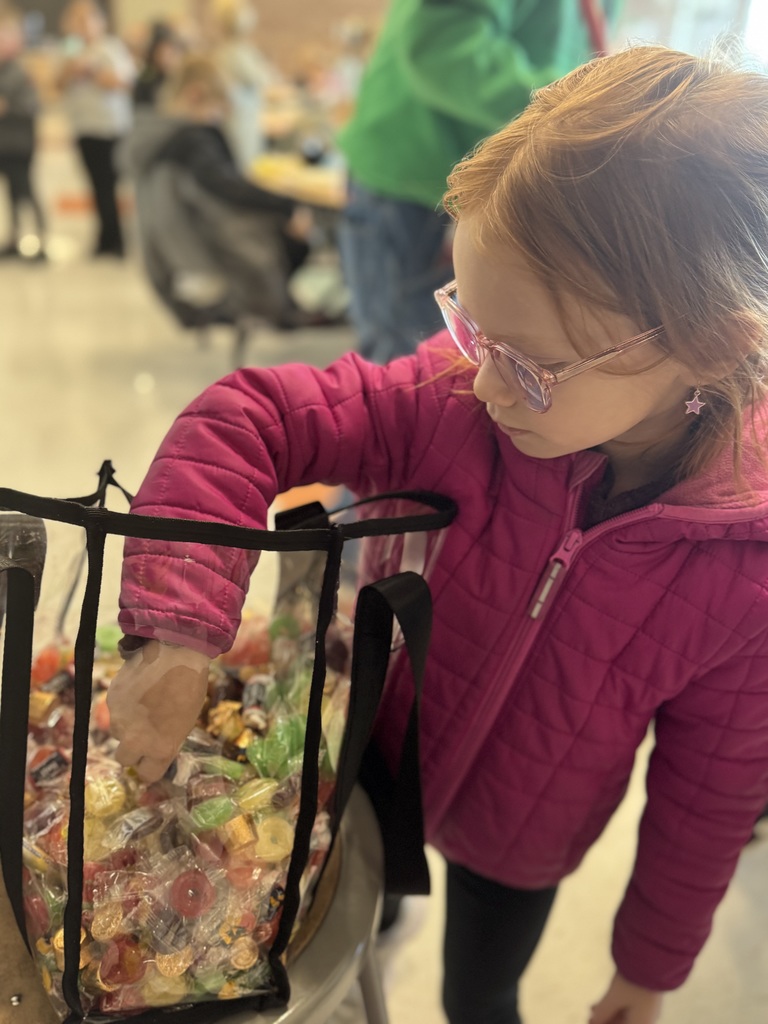 student pulling candy from a bag