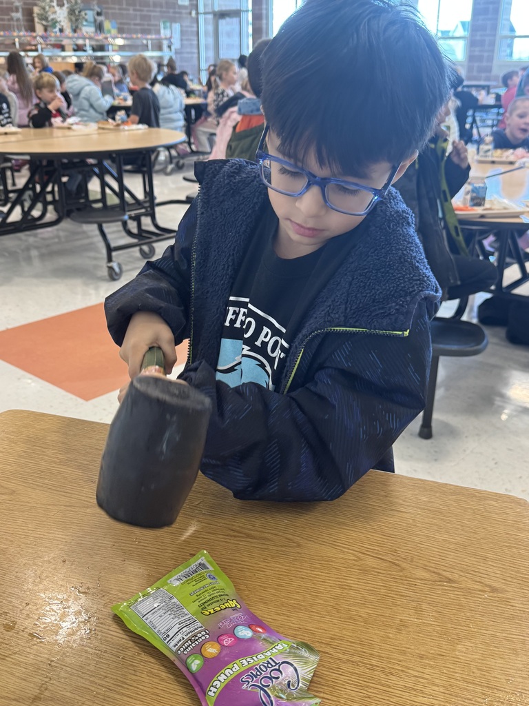 student using mallet on slushie