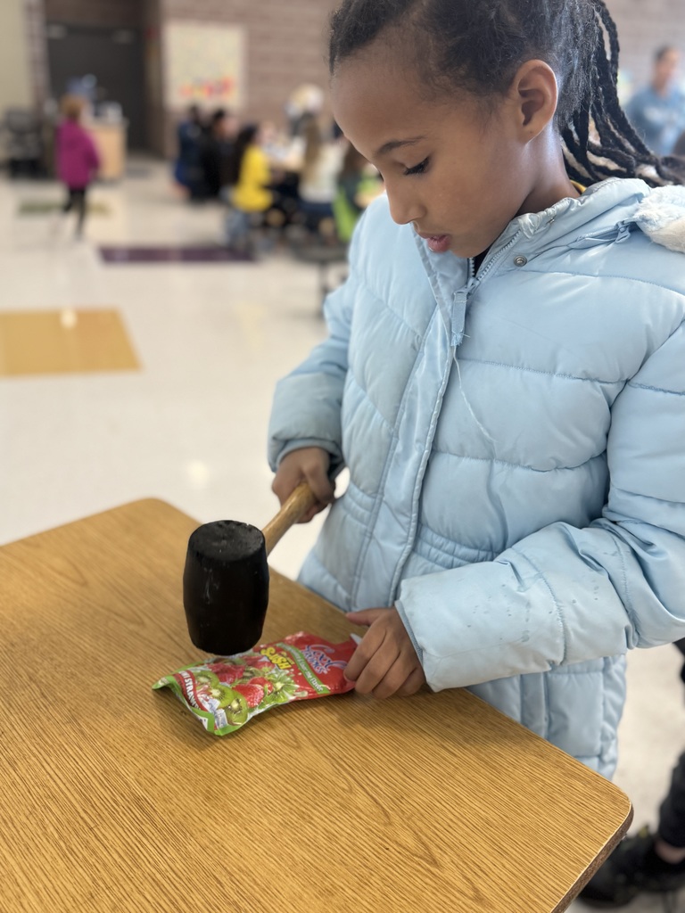 student using mallet on slushie