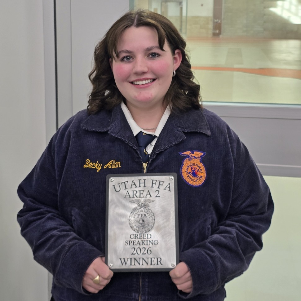 Cale holding her FFA award for 2026 Creed Speaking winner