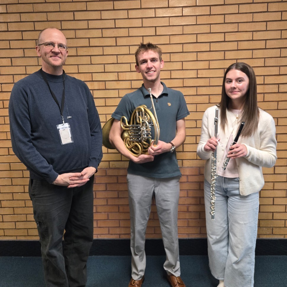 Mr. Follett, Flint, and Claire posing for a picture after All State Band