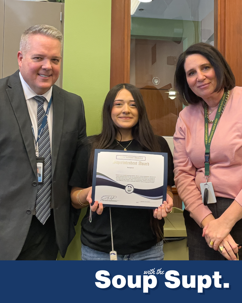 A student holding up a certificate posing with their principal and the superintendent for Soup with the Supt. 