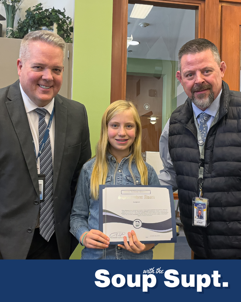 A student holding up a certificate posing with their principal and the superintendent for Soup with the Supt. 