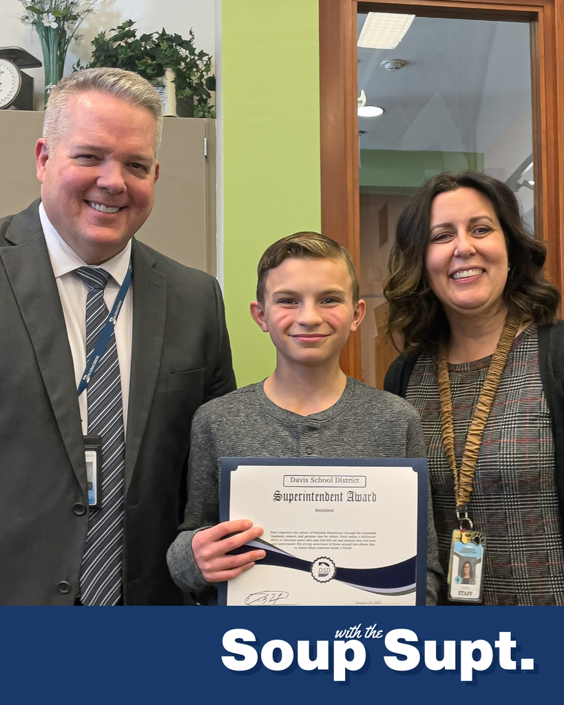 A student holding up a certificate posing with their principal and the superintendent for Soup with the Supt. 